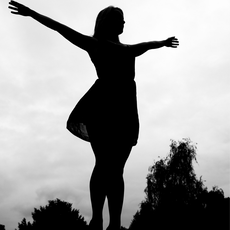 Black and white silhouette, girl with skirt, arms out to the sides, 