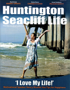 Nancy in a floral dress in the water on the cover of Huntington Seacliff Life